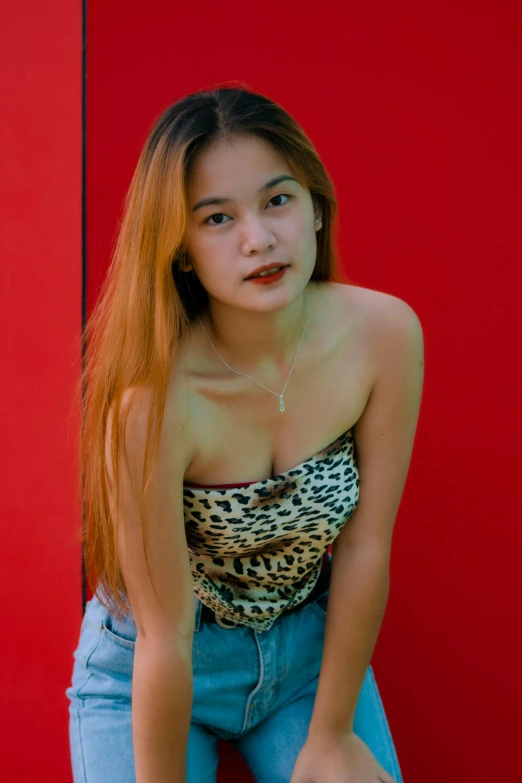a girl posing  wearing a cheetah shirt