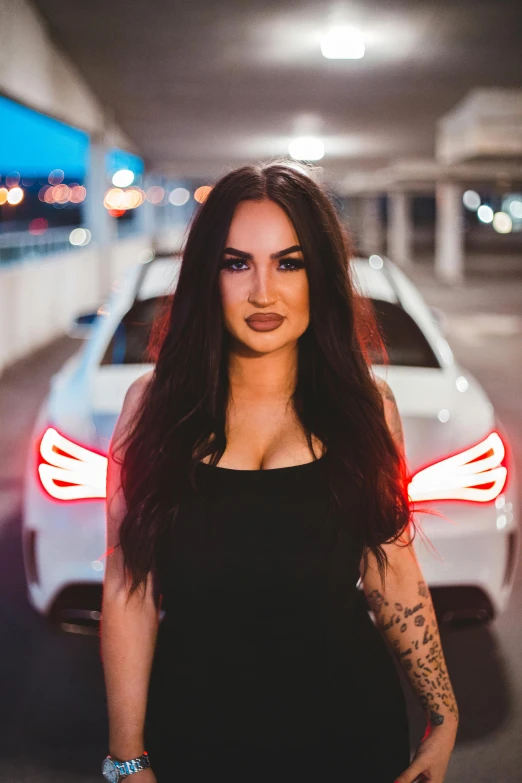 a woman standing in front of a car