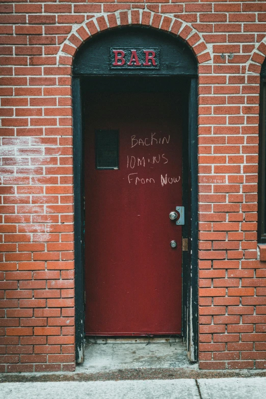 the red door has been painted with the word bar