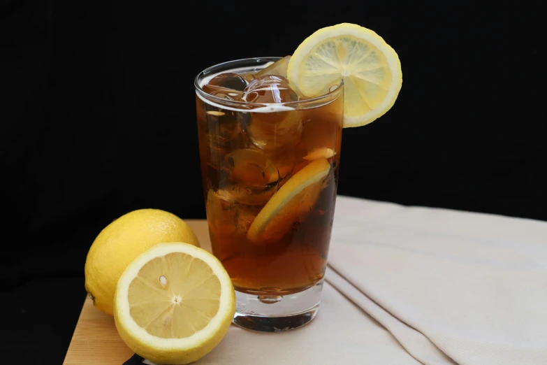 a drink on a wooden table with lemons