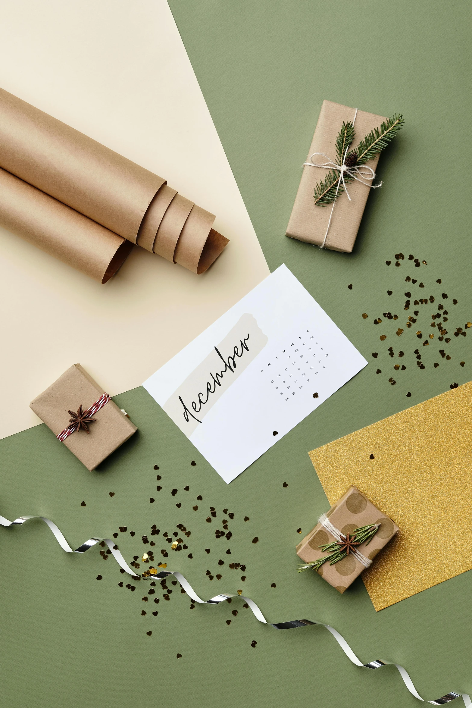 a brown package on top of a green table with some ribbon and tags around it