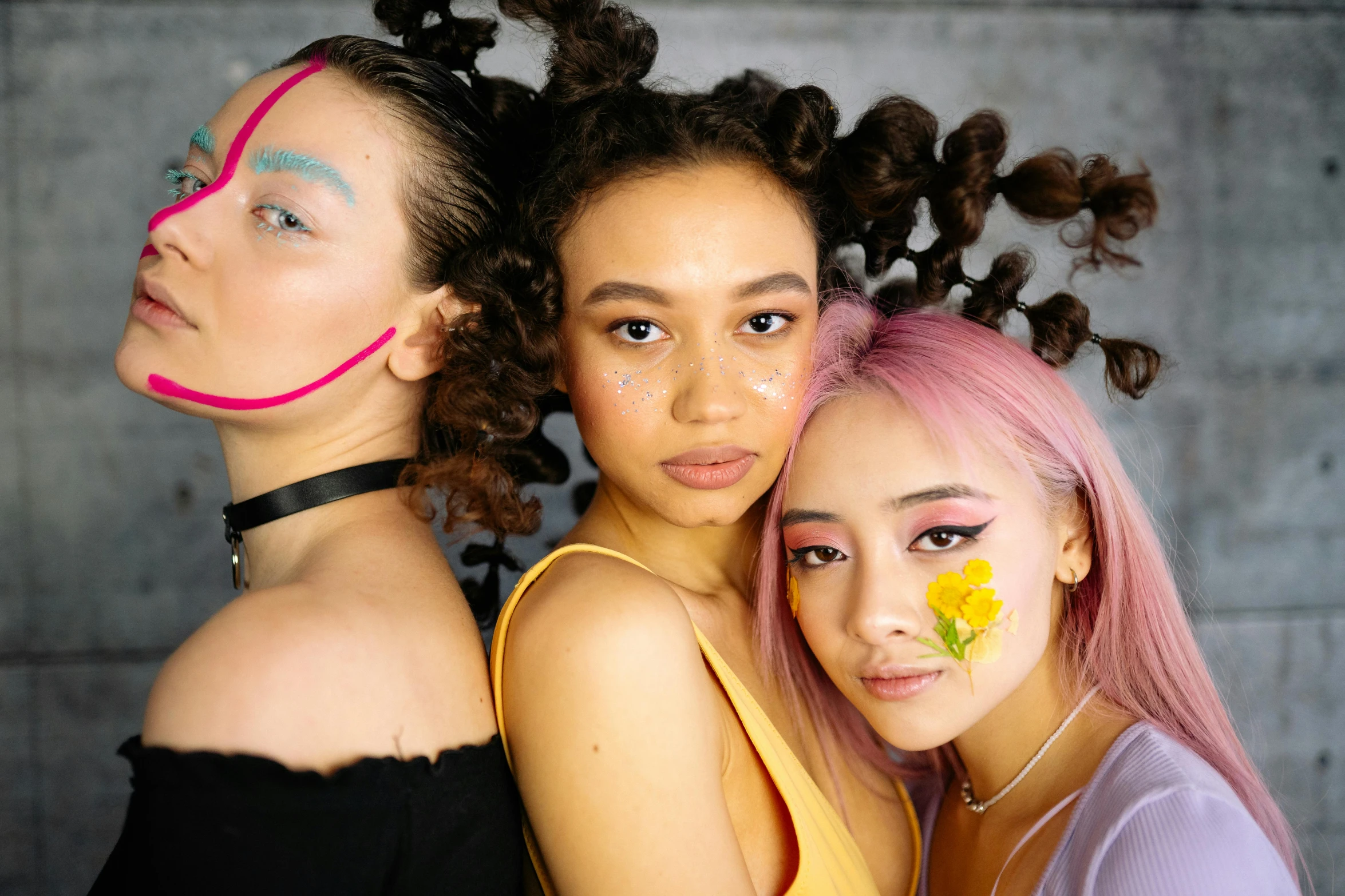 four young women are standing next to each other