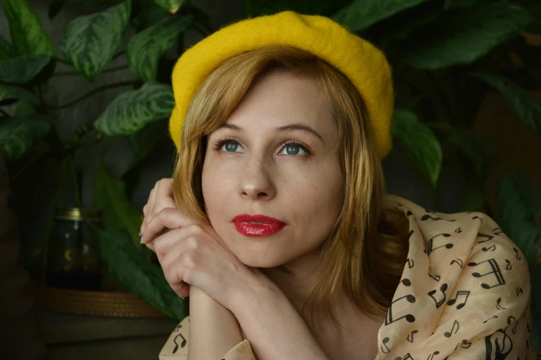 a woman with a yellow hat and scarf