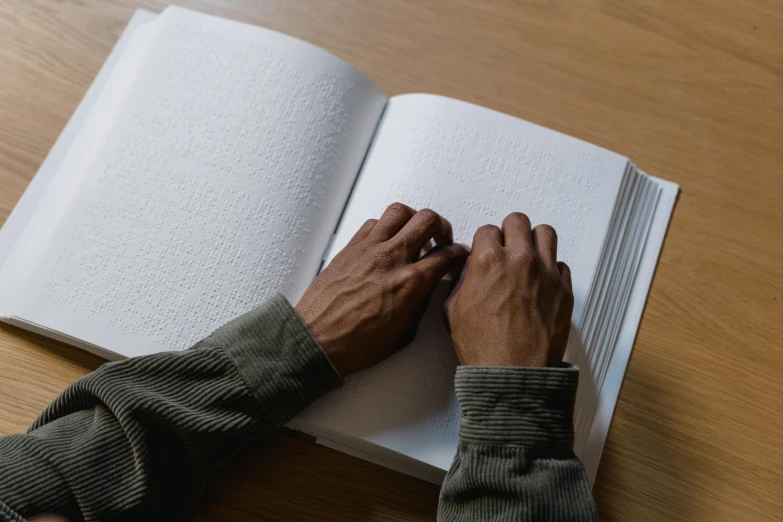 a man reading a book and writing soing