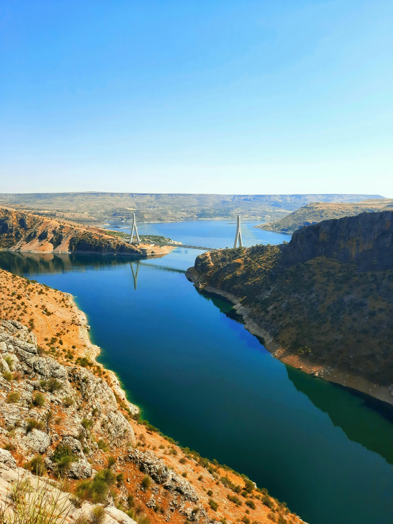 a river in an arid area next to mountains