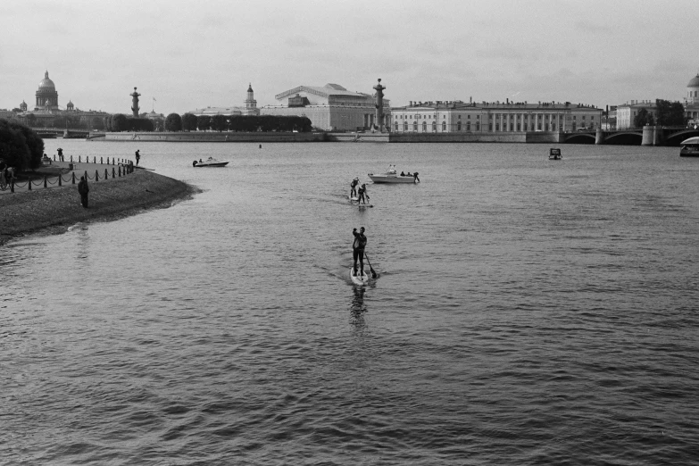 an image of people rowing on the lake