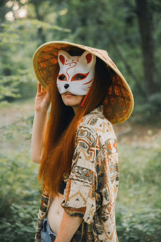 woman with long red hair wearing an animal face mask