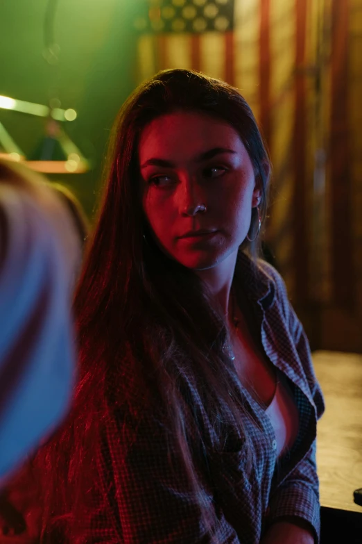 a woman sitting on a couch with light coming through her window