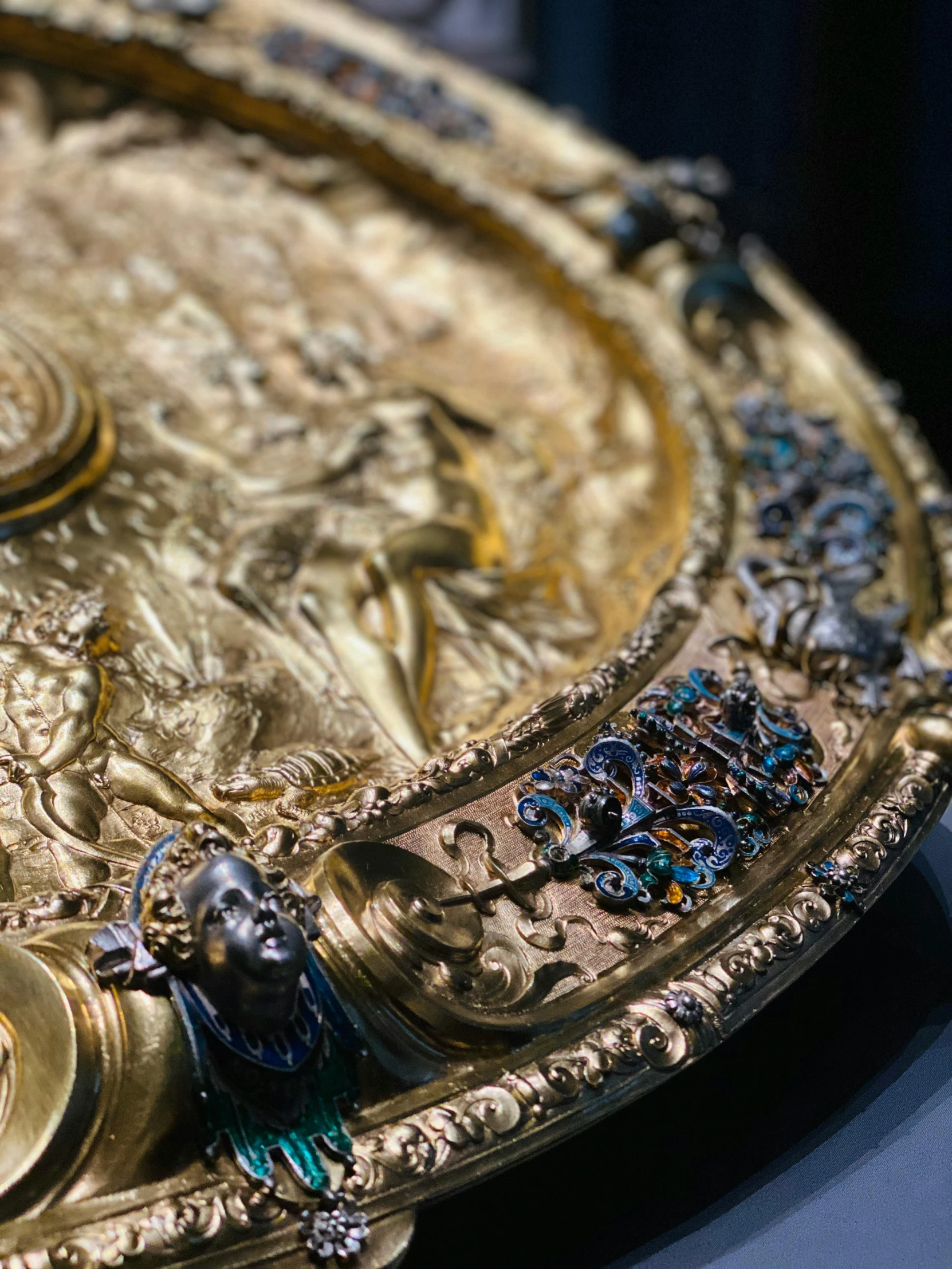 a decorative plate covered in jewels and gems