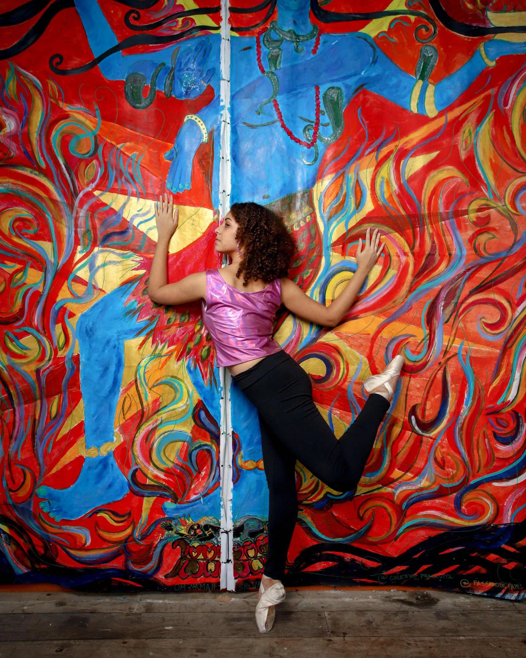 girl standing in front of painting posing for the camera