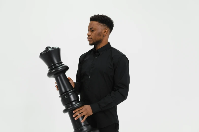 a black man with a giant pawn chess piece