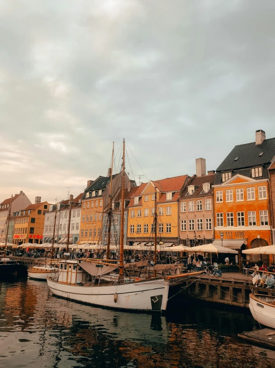 the boats are parked next to the large buildings