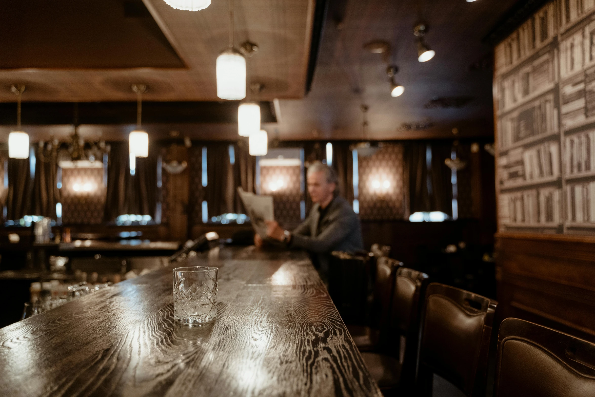 a wooden table sitting in front of a bar