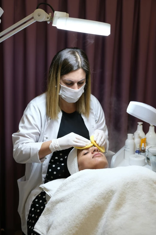 a woman is undergoing a dental check