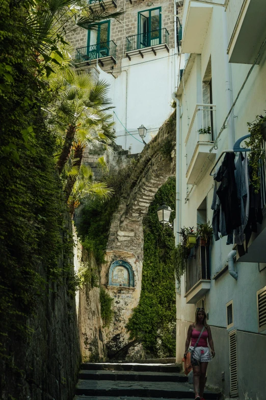 a woman walks up the street on some stairs