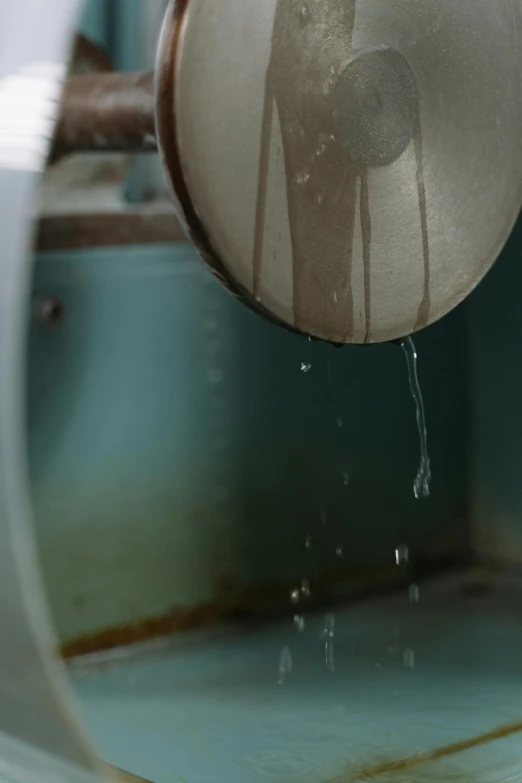 a person is holding a toilet with water pouring out of it