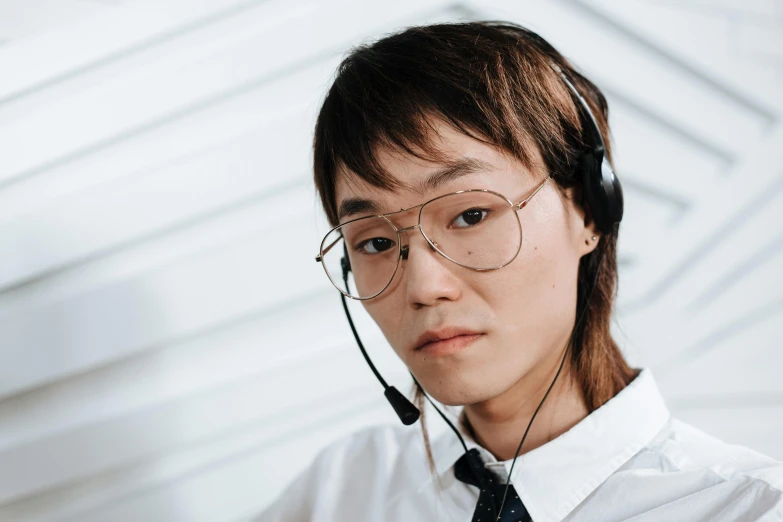 a male wearing headphones and a white shirt