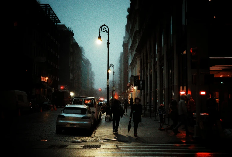 a couple of people walk across a street