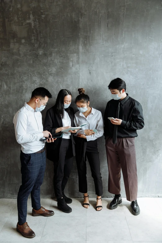 people are dressed in business attire looking at papers