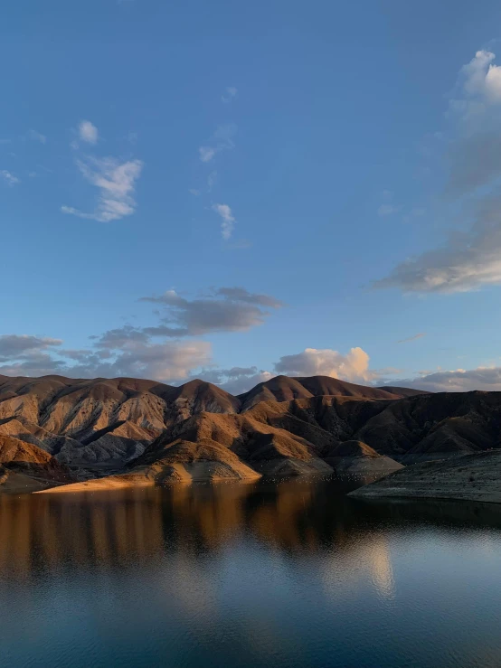 a large body of water surrounded by hills