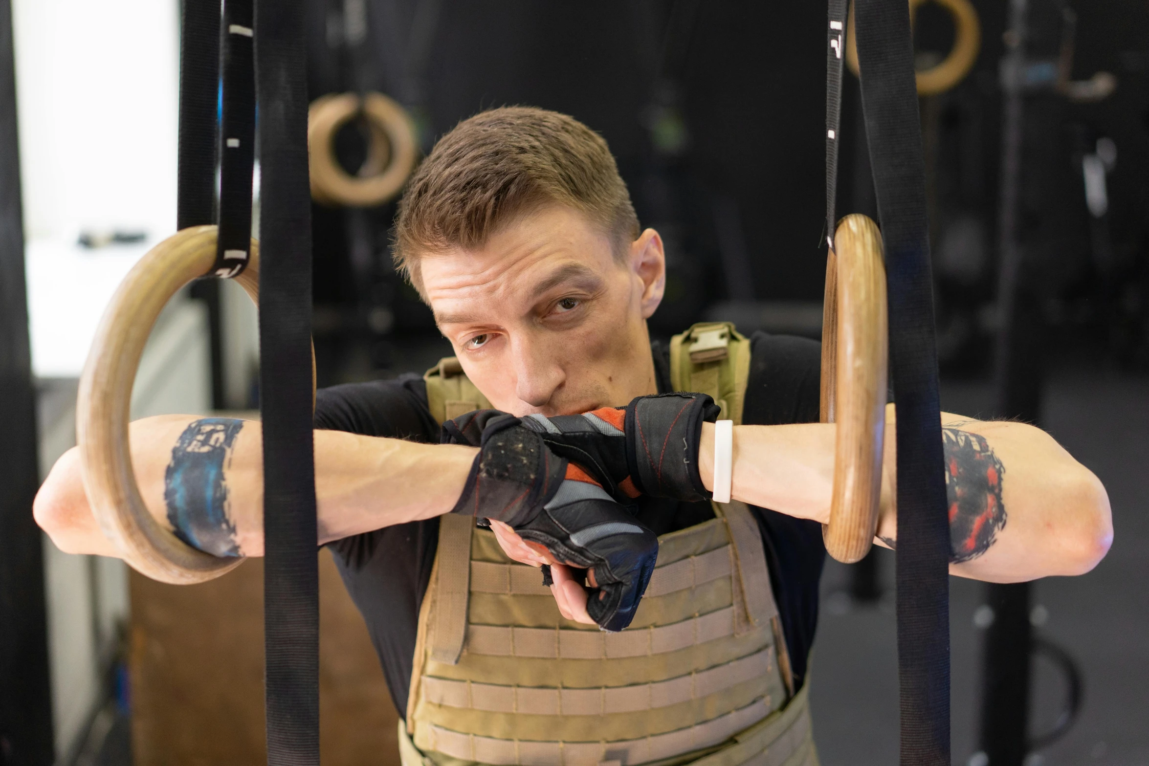 a man standing behind bars in the gym