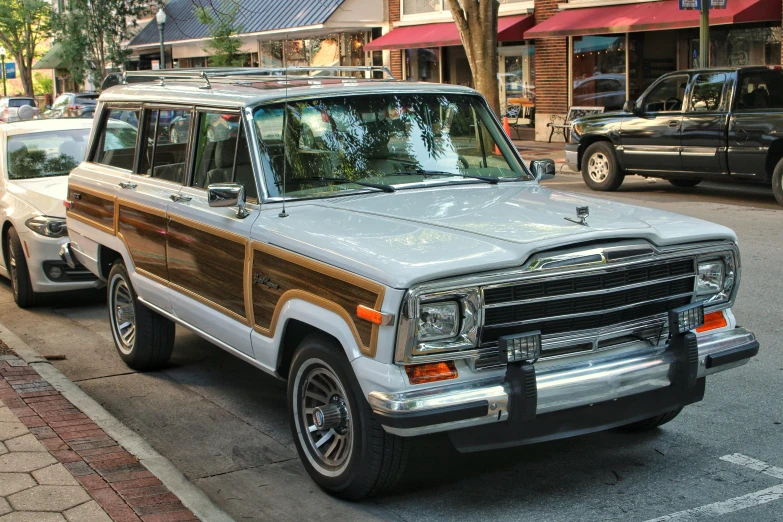 a silver vehicle on road next to another vehicle