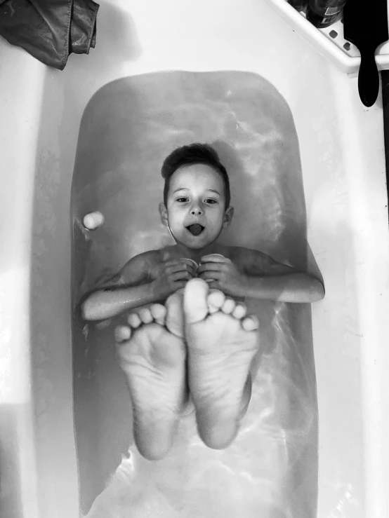 a child is in the water and has his feet up