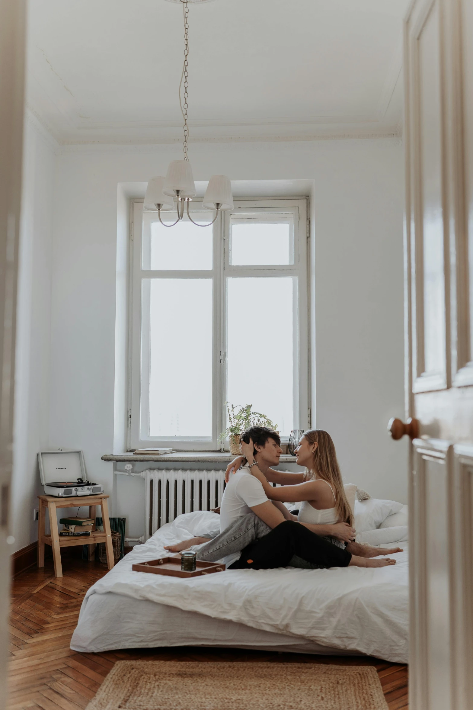 a man and woman are sitting on the bed