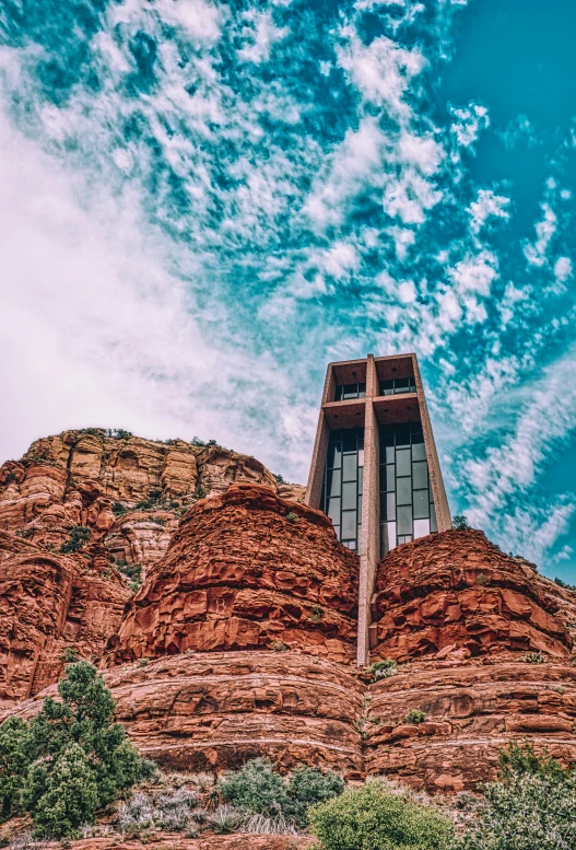 a po of the top of red rocks with a cross at the base