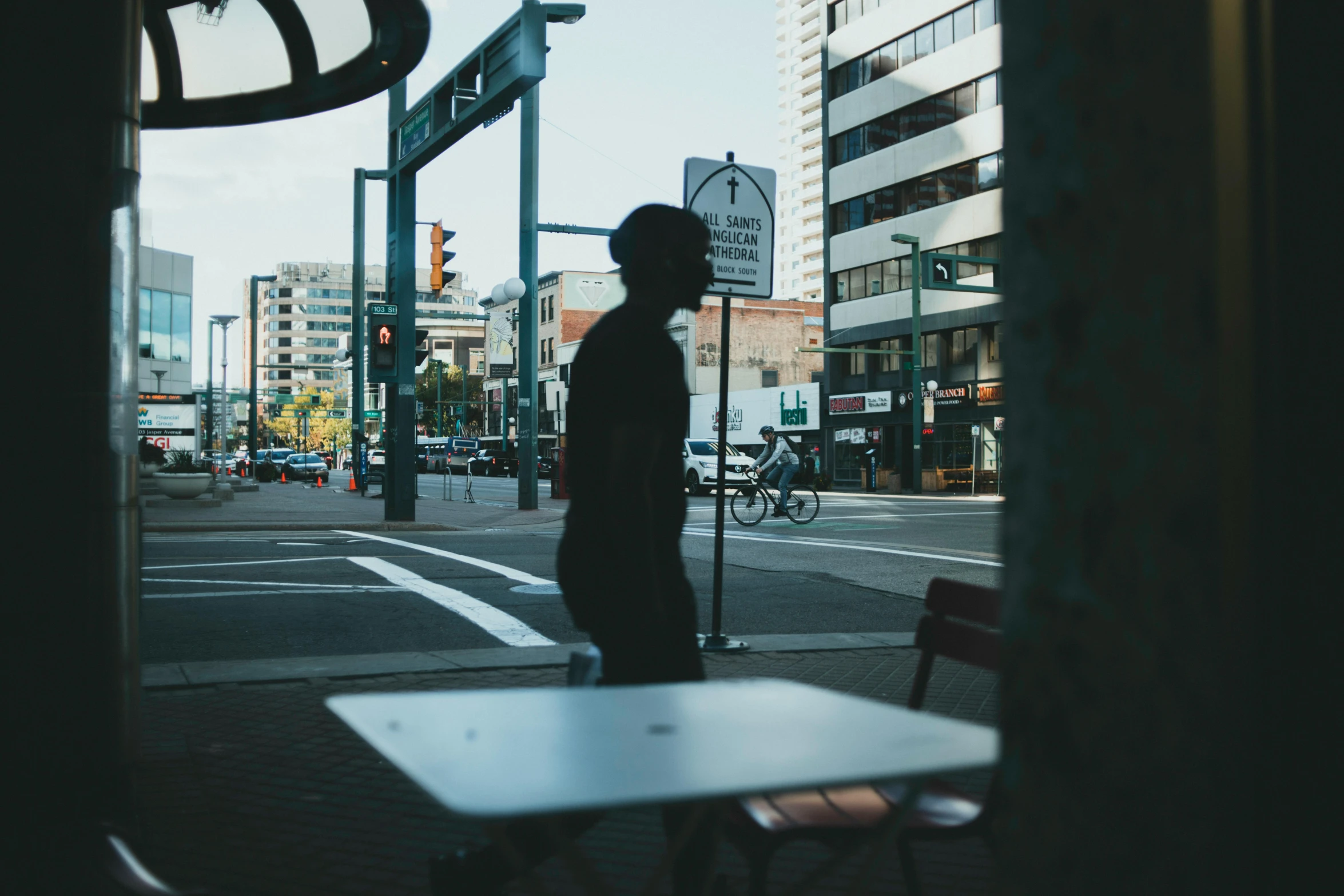 a man standing at a table on the side of a street