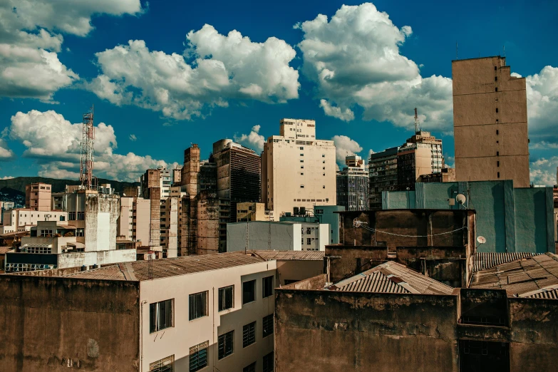 some buildings a blue sky clouds and white clouds