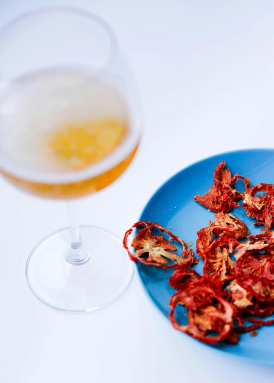 a plate with a sliced piece of food on it next to a glass of beer