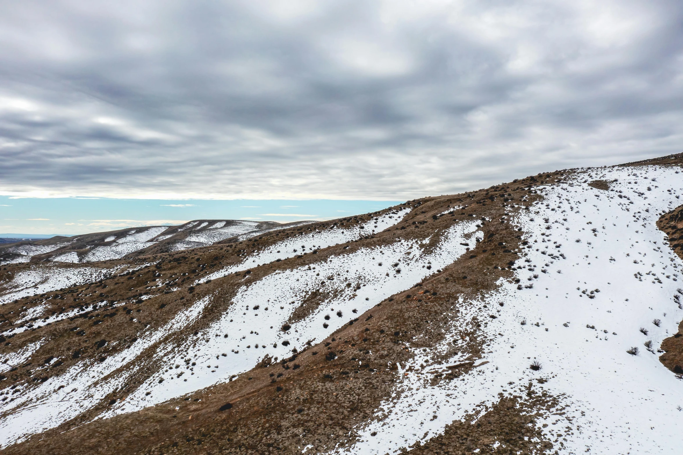 the view from the top of the snowy mountain