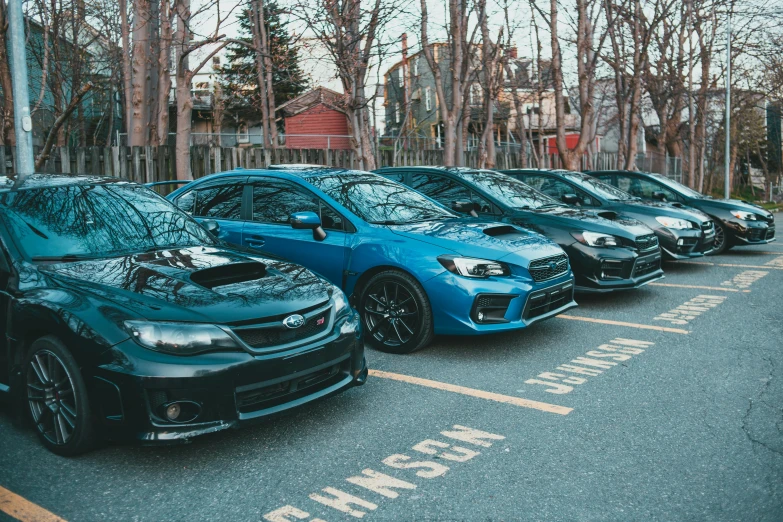 a line of cars parked in a row at a station