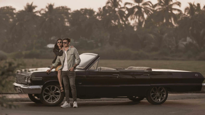 a man standing next to a woman by a car