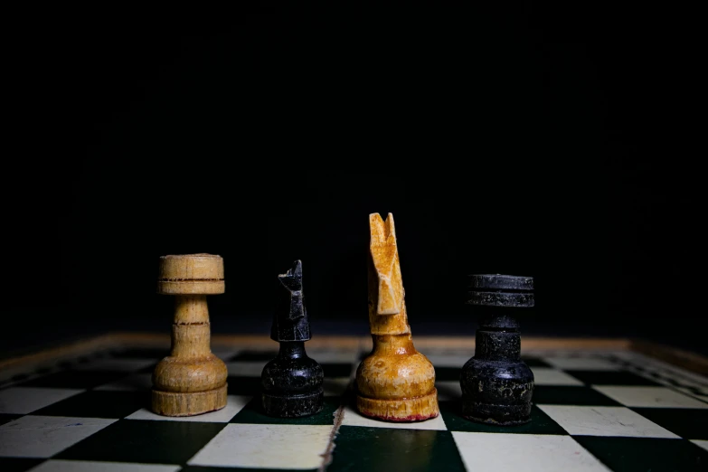 several chess pieces arranged on a checkered table