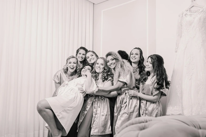 a bride and her bridesmaids pose for a picture