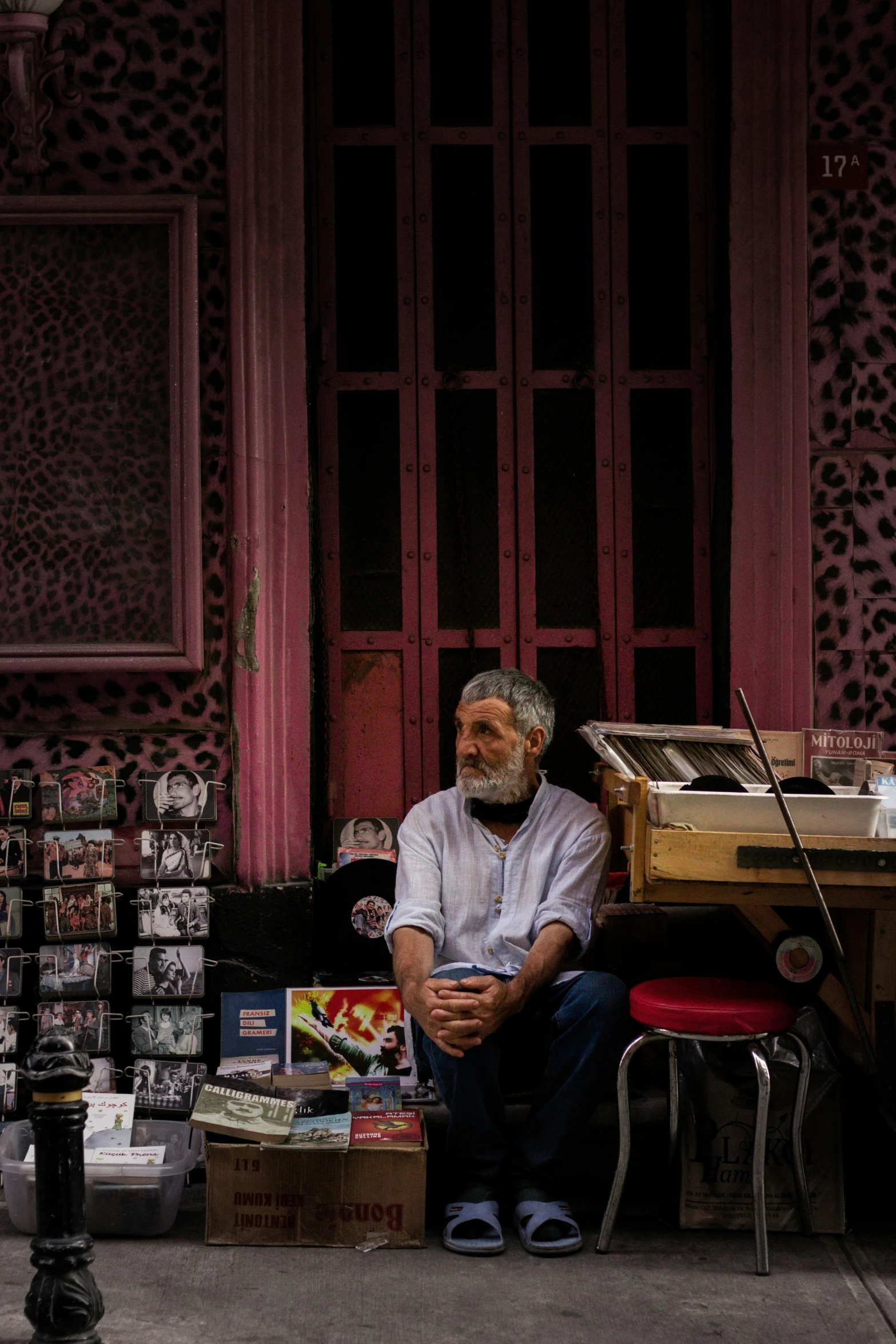 a man sitting in front of a store on the street