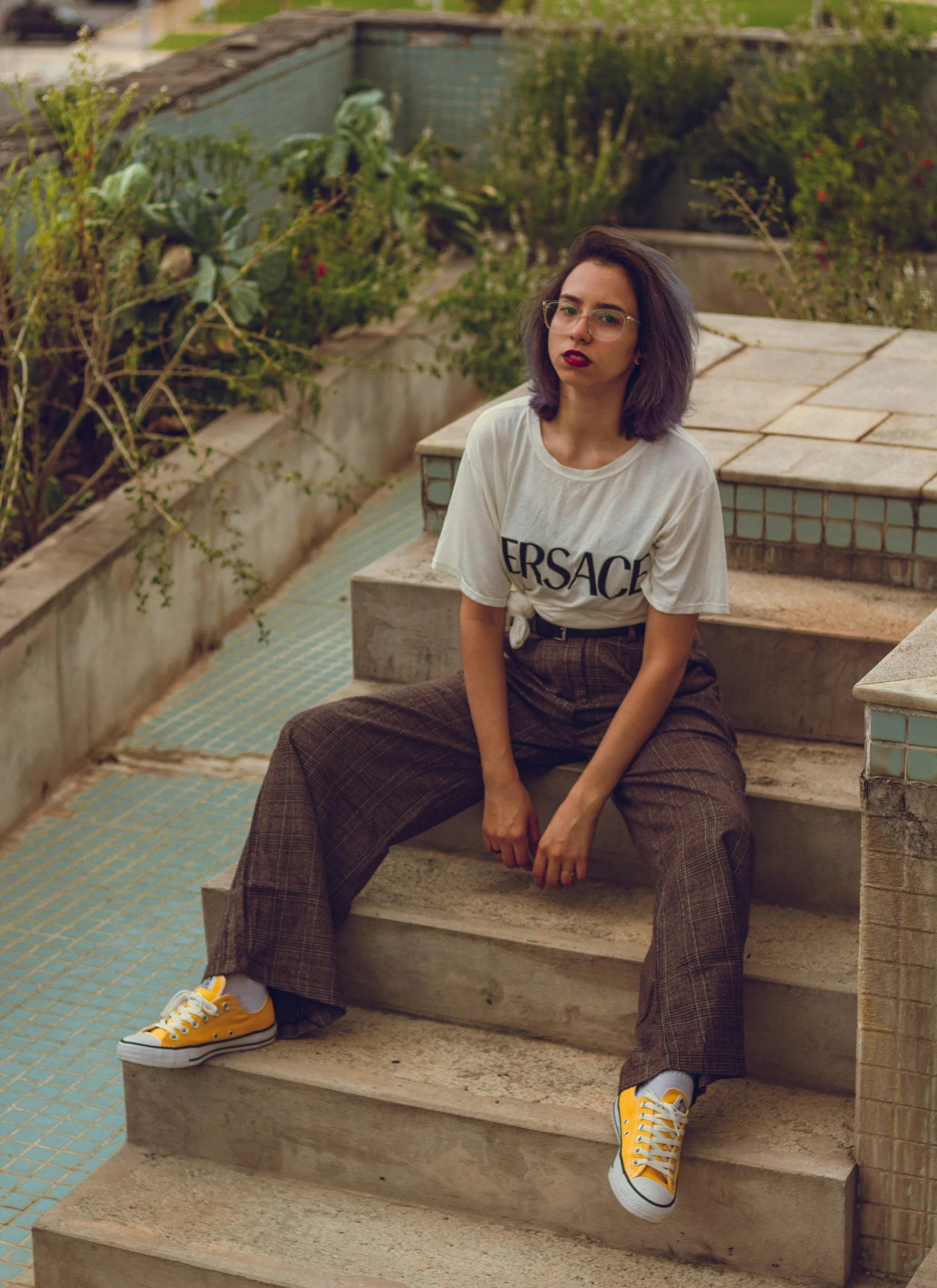 a woman sitting on some steps outside