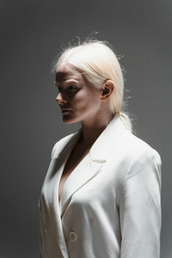 the woman is posing in white clothes with a white hair