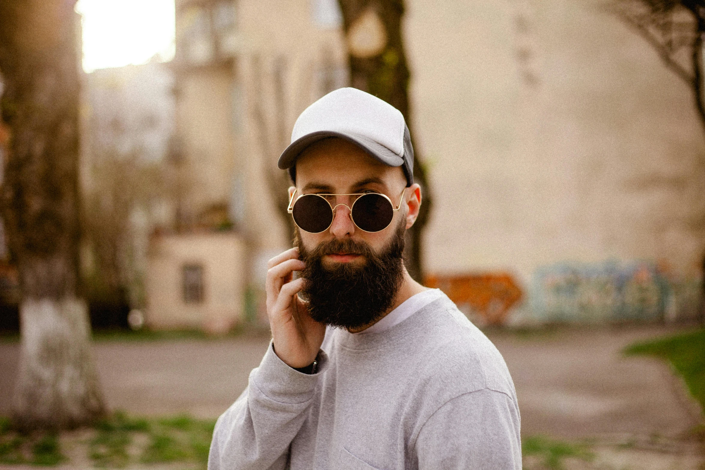 a man talking on a phone while wearing sunglasses