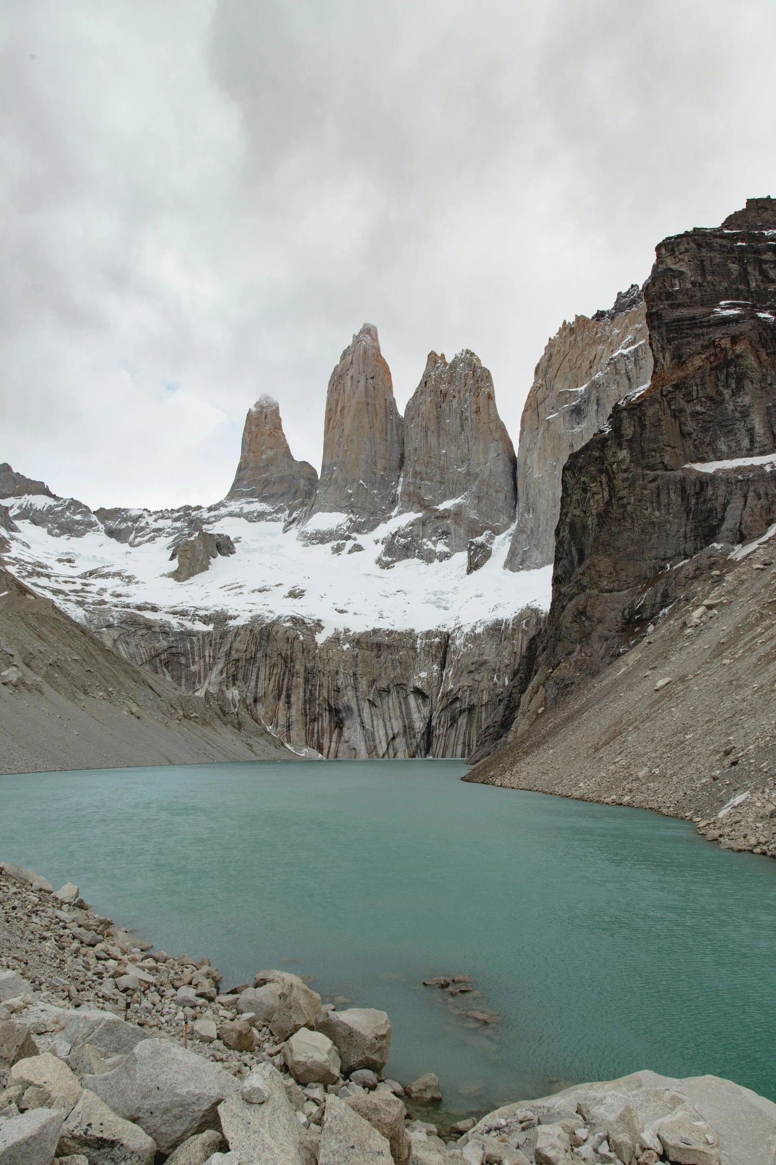 snowy mountains near a body of water under a sky