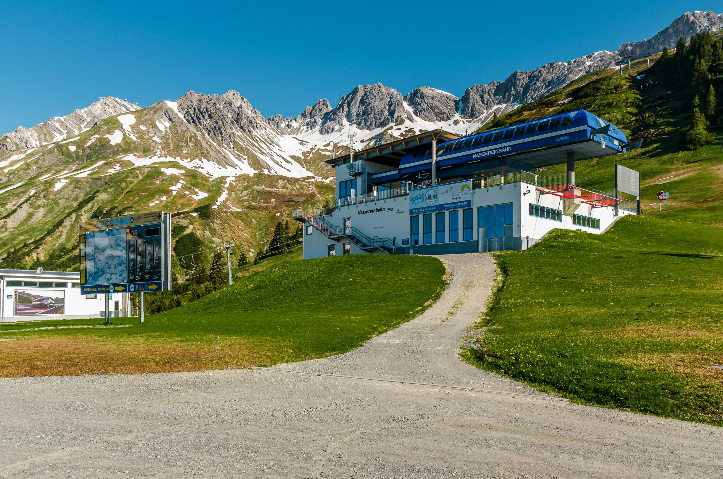 a road passes under the top of a large building