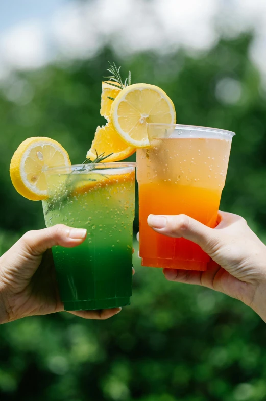 a couple of people are holding beverages in their hands