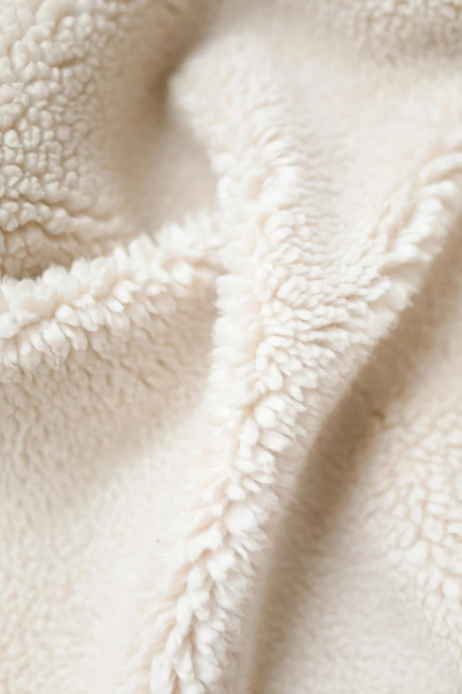 white blanket with an overlay of wavy, soft material