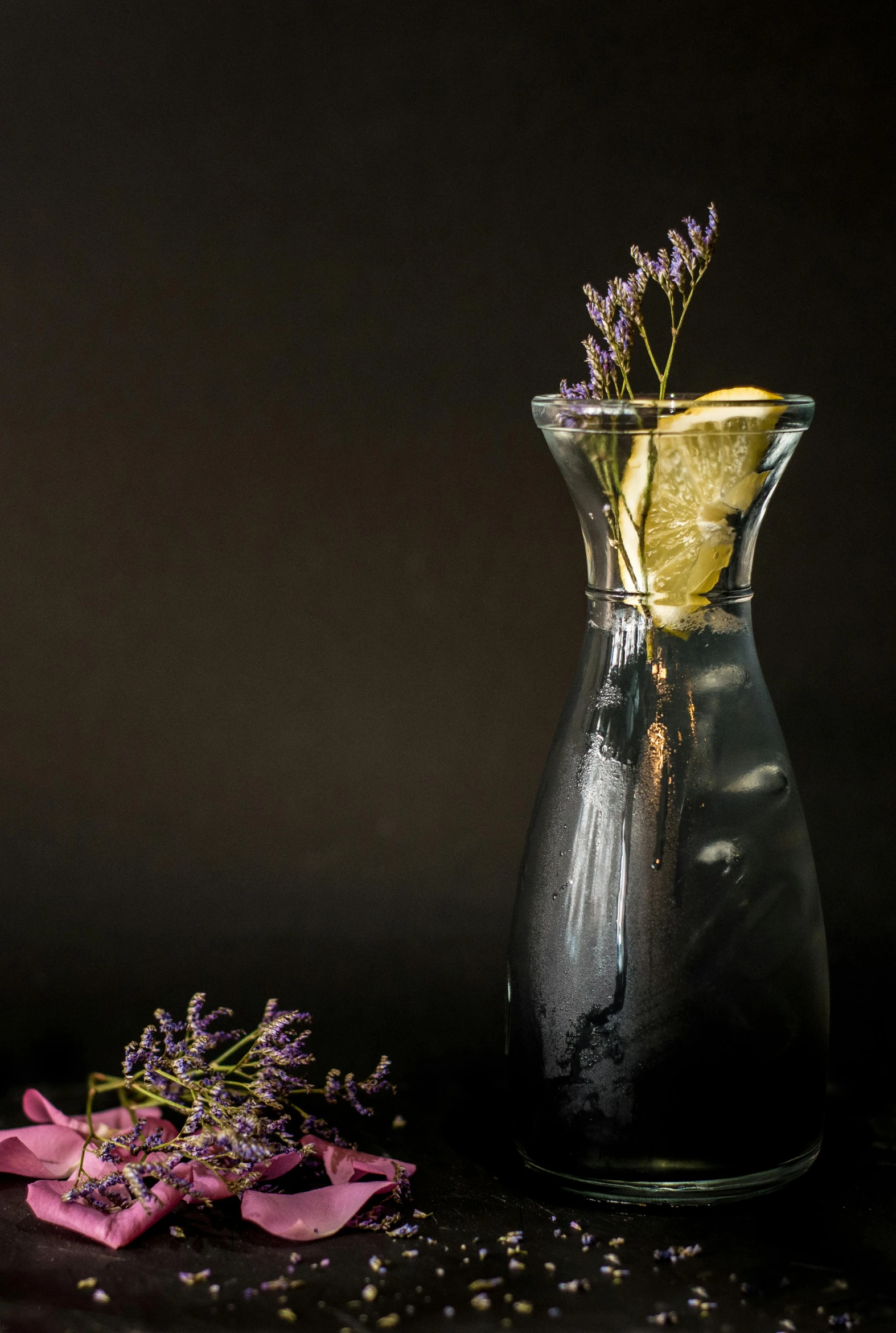 a vase with a bunch of lemon slices next to it