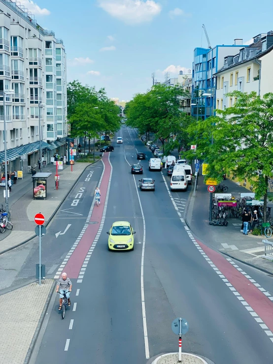 an urban street with bicycles, cars and buildings