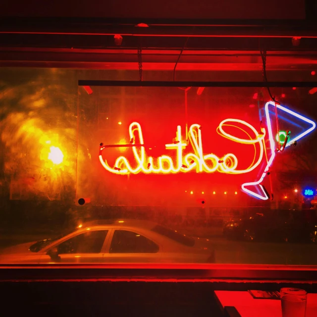 a neon sign sitting in the window of a store