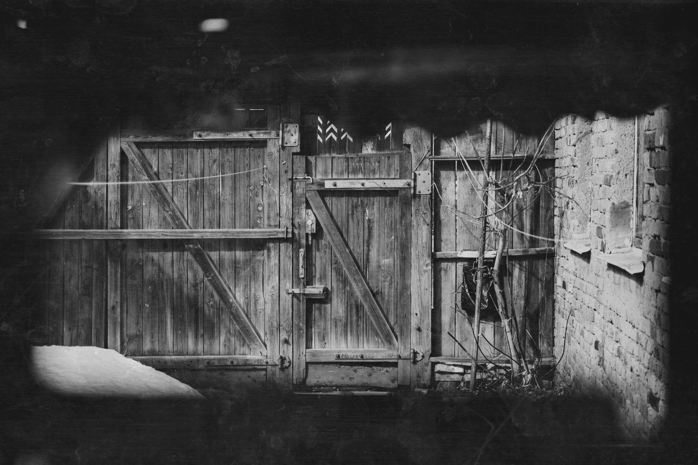 black and white po of wooden gated entrance