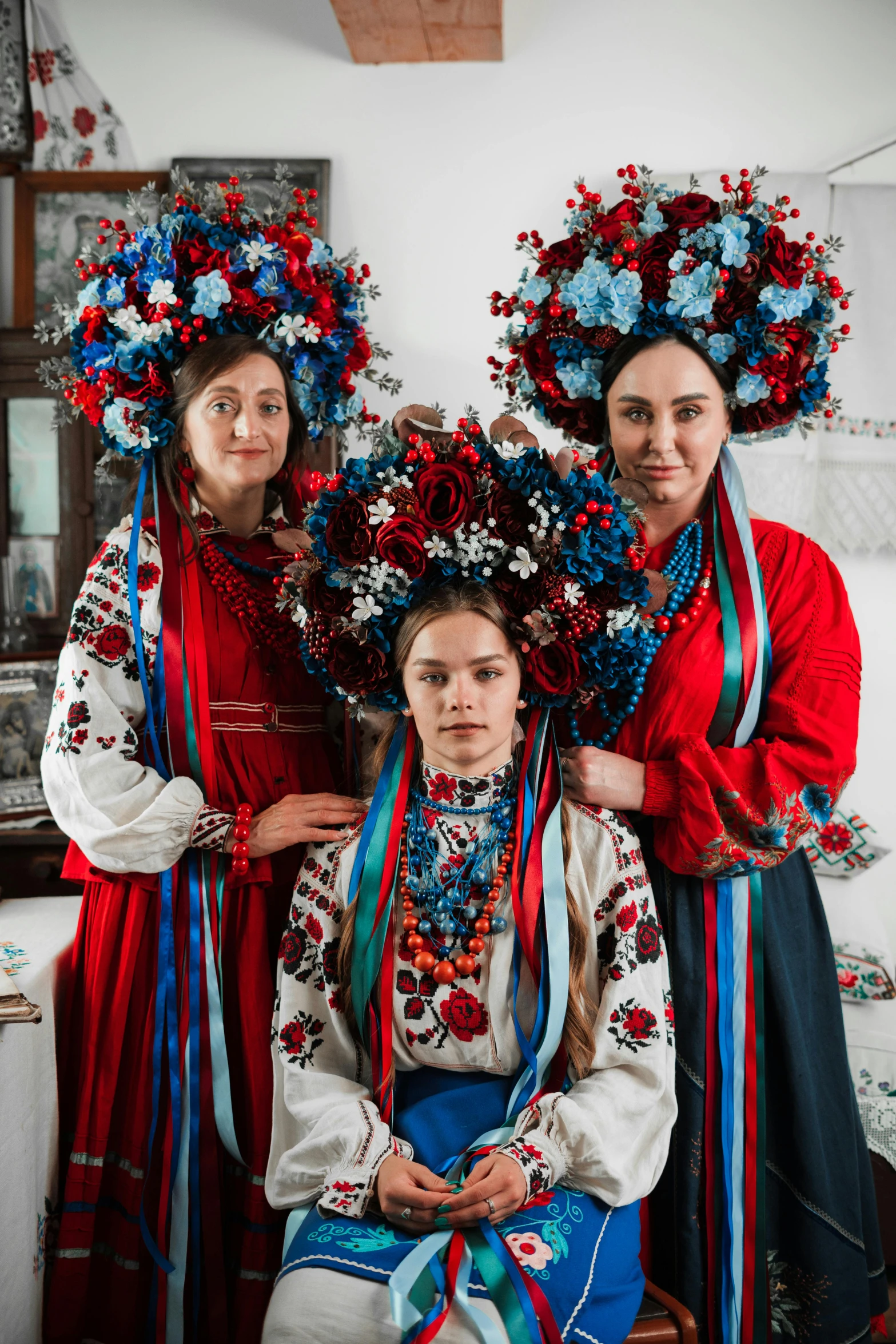 three beautiful young women standing next to each other wearing colorful costume